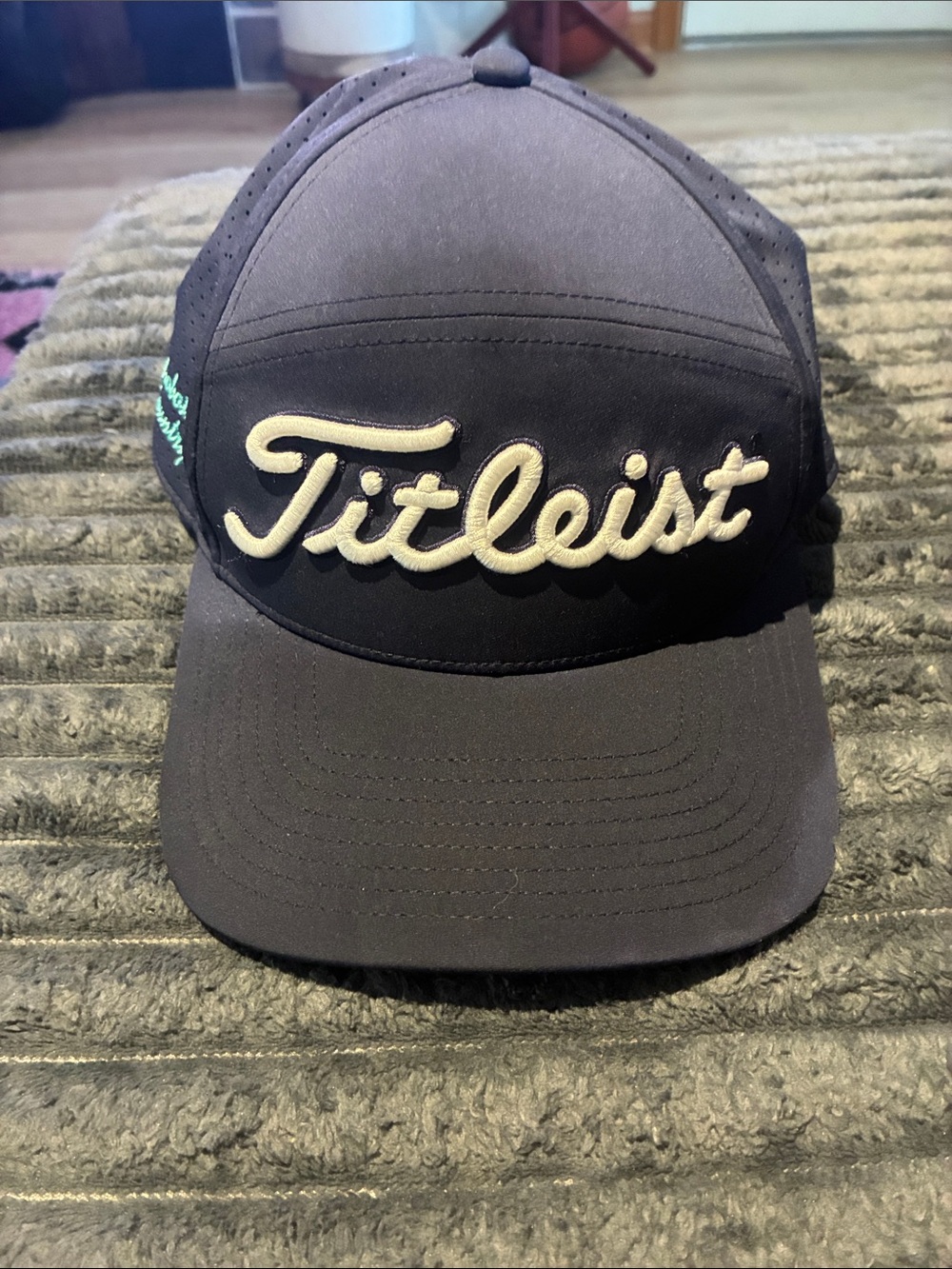 Titleist Navy Blue snapback with Cream Script Logo